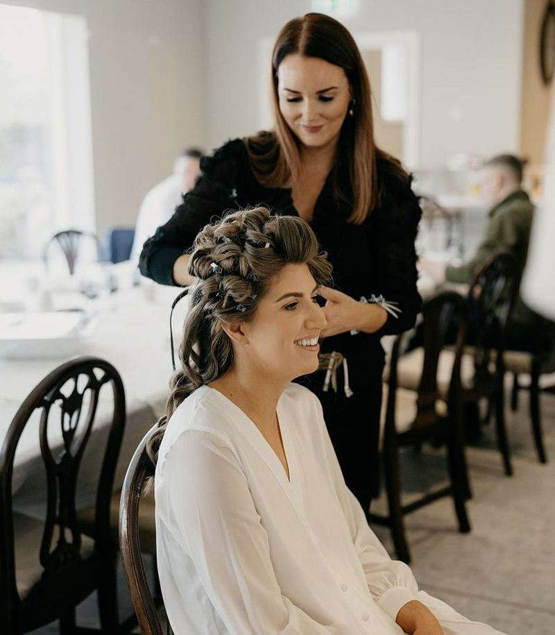 Laura styling a bride’s braided updo